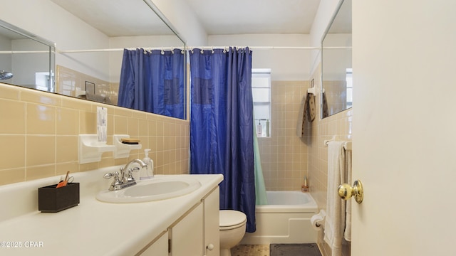 bathroom featuring shower / bath combo, toilet, backsplash, vanity, and tile walls