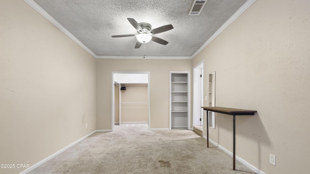 interior space featuring carpet floors, visible vents, ceiling fan, and a textured ceiling