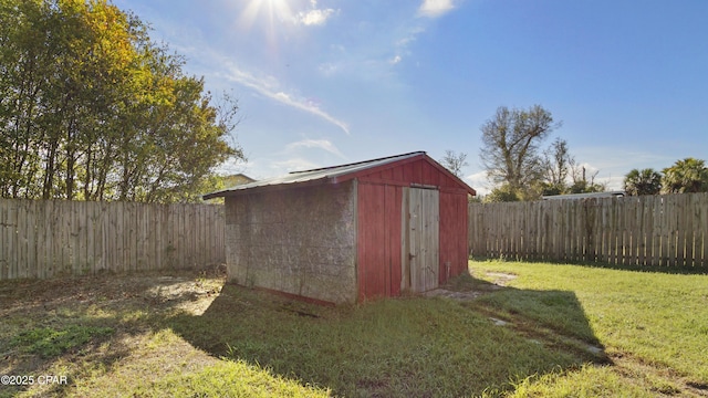 view of shed with a fenced backyard