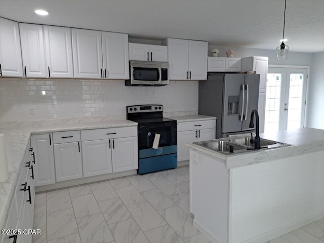 kitchen featuring marble finish floor, appliances with stainless steel finishes, a sink, and white cabinets