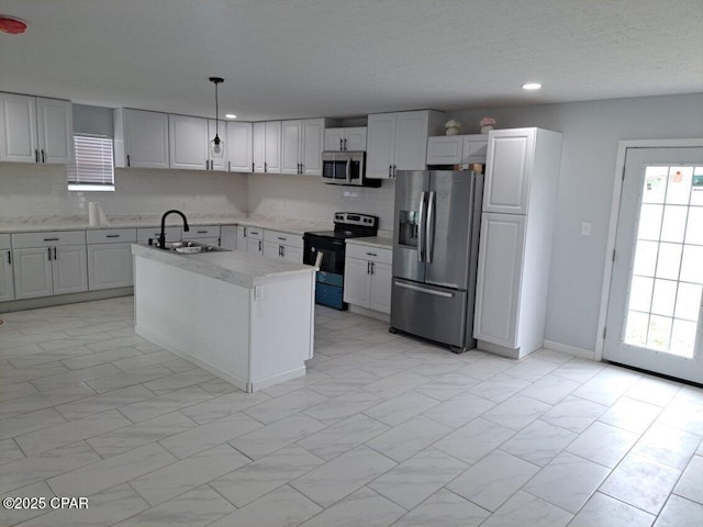 kitchen featuring marble finish floor, stainless steel appliances, a sink, and decorative backsplash