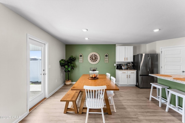 dining space featuring a wealth of natural light, light wood-type flooring, baseboards, and recessed lighting