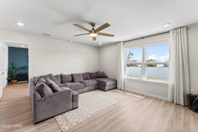 living area with recessed lighting, visible vents, a ceiling fan, wood finished floors, and baseboards