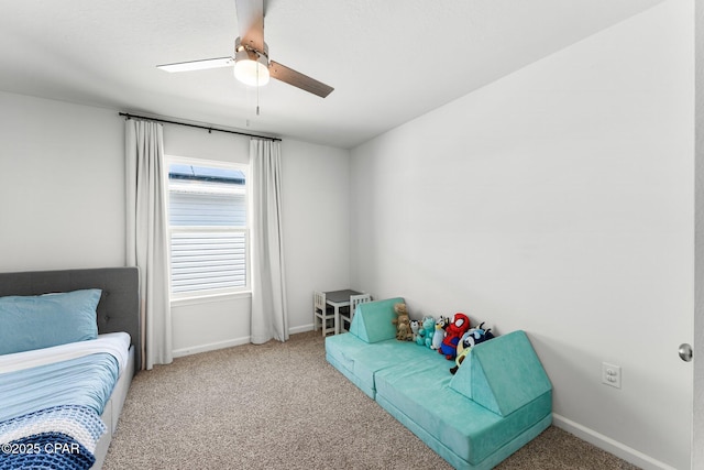 carpeted bedroom featuring a ceiling fan and baseboards