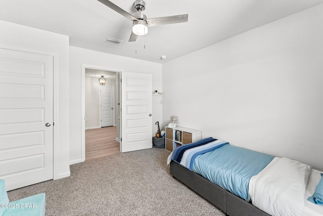 bedroom featuring a ceiling fan, carpet, visible vents, and baseboards