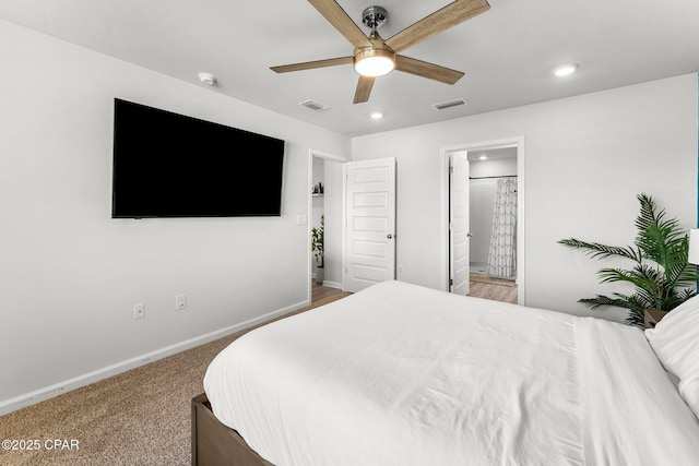 carpeted bedroom with recessed lighting, visible vents, ceiling fan, ensuite bath, and baseboards