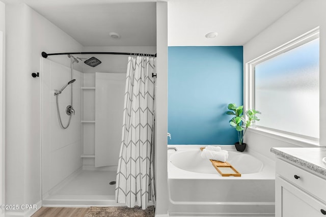 bathroom featuring curtained shower, vanity, and a bath