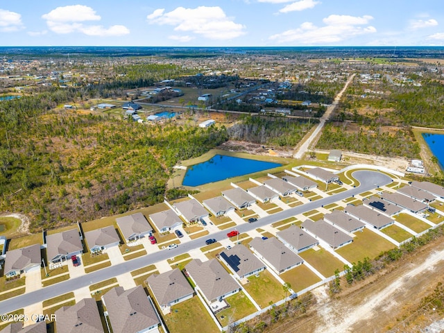 birds eye view of property with a residential view and a water view