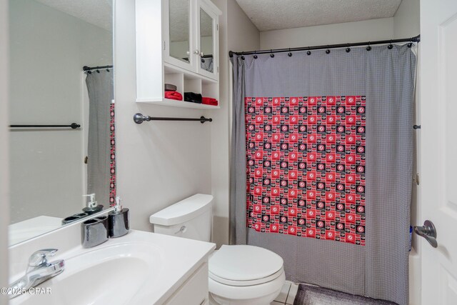 5429 Blue Dog Rd, Panama City, FL 32404 - bathroom with toilet, vanity, and a textured ceiling