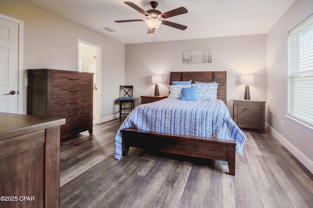 5429 Blue Dog Rd, Panama City, FL 32404 - bedroom with wood finished floors, baseboards, ceiling fan, and ensuite bath