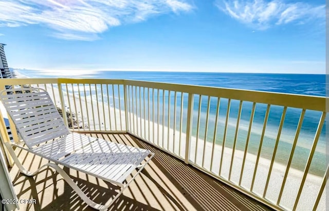 balcony featuring a water view and a beach view