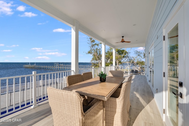 exterior space with a water view, a balcony, and a ceiling fan