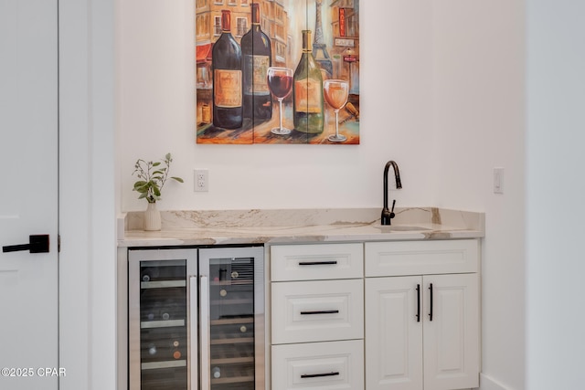 bar with wine cooler, a sink, and a bar