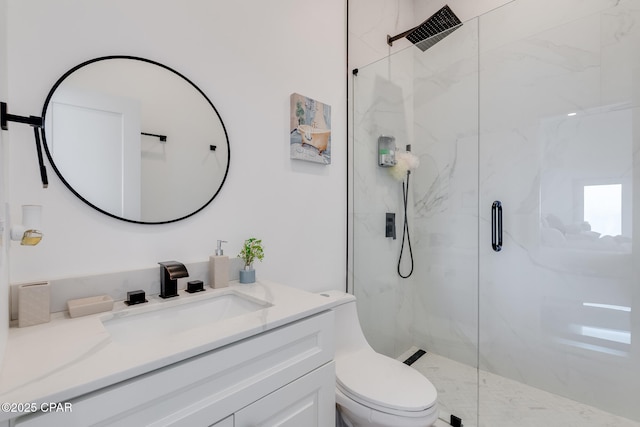 full bathroom featuring toilet, a marble finish shower, and vanity