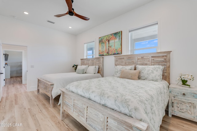 bedroom with light wood-type flooring, baseboards, visible vents, and recessed lighting