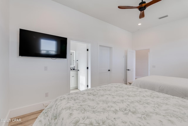 bedroom with recessed lighting, visible vents, light wood-style floors, ensuite bath, and baseboards