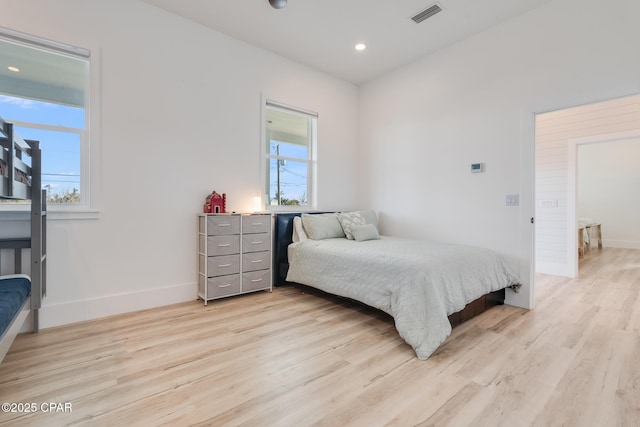 bedroom with light wood-type flooring, visible vents, baseboards, and recessed lighting