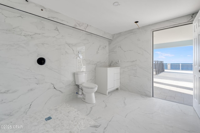 bathroom featuring toilet, stone wall, a marble finish shower, and marble finish floor