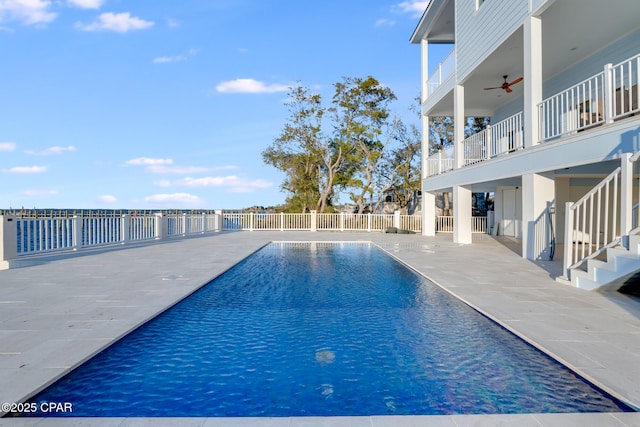 view of pool with a fenced in pool, stairway, a patio area, ceiling fan, and fence