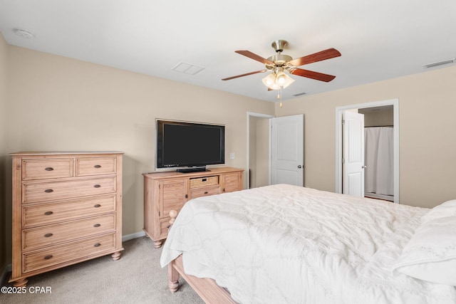 bedroom with ceiling fan, visible vents, and light colored carpet