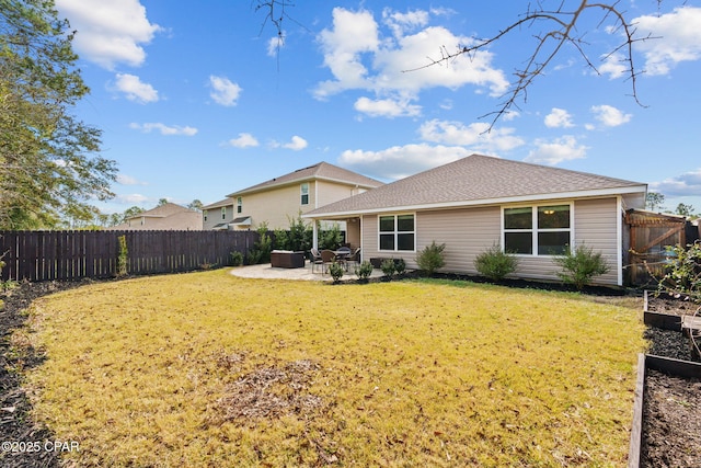 rear view of house with a yard, a patio area, and a fenced backyard