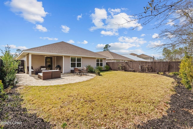 back of property featuring a patio, a shingled roof, a lawn, an outdoor hangout area, and fence