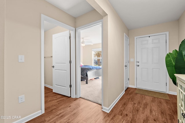 entryway featuring baseboards and light wood-style floors