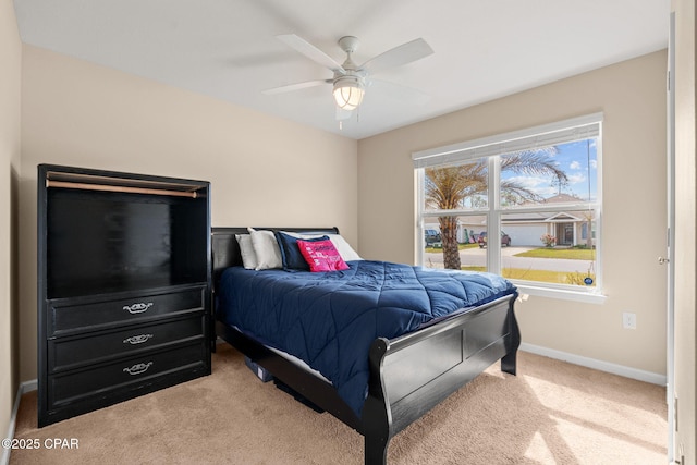 bedroom with carpet, baseboards, and a ceiling fan