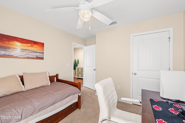 bedroom with ceiling fan, visible vents, and light colored carpet