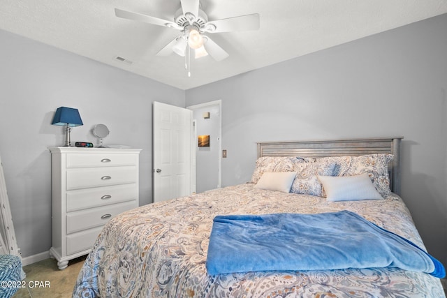 carpeted bedroom featuring baseboards, visible vents, and a ceiling fan