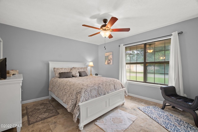 bedroom featuring baseboards and a ceiling fan