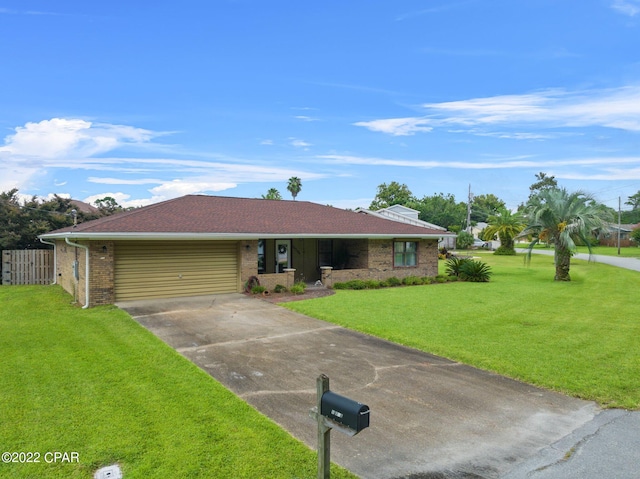 ranch-style house with concrete driveway, an attached garage, fence, a front lawn, and brick siding