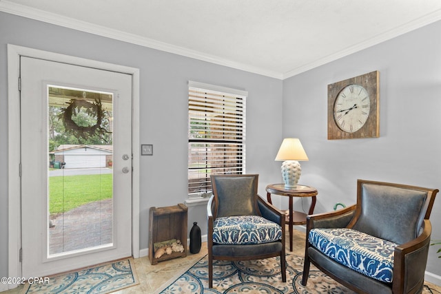 sitting room featuring ornamental molding, plenty of natural light, baseboards, and tile patterned floors