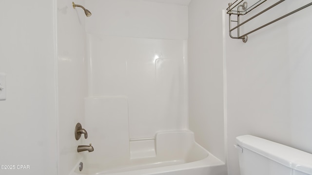 bathroom with tub / shower combination and toilet