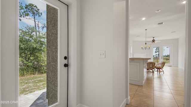 interior space with light tile patterned floors, visible vents, baseboards, and recessed lighting