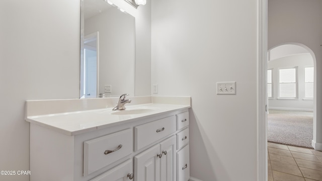 bathroom with vanity, baseboards, and tile patterned floors