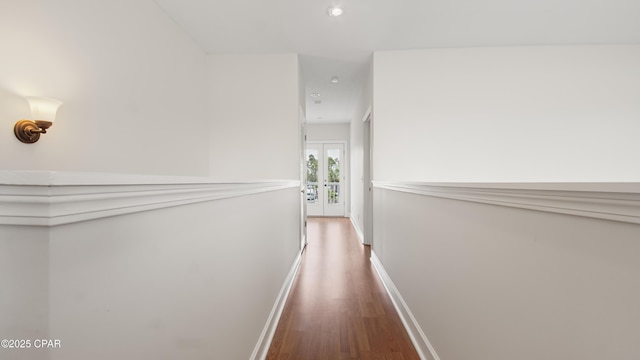 hall featuring baseboards and wood finished floors