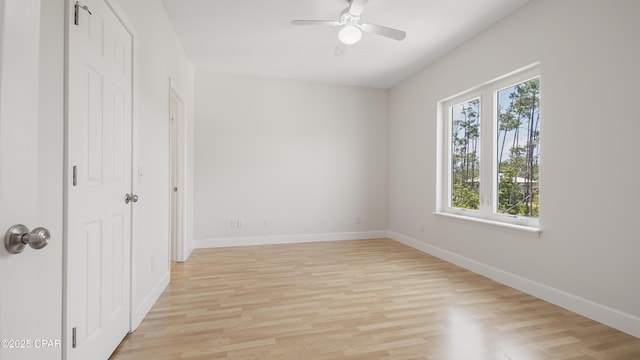 unfurnished bedroom with light wood-style floors, baseboards, and a ceiling fan