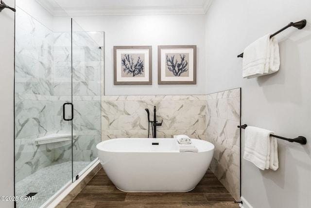 6627 Thomas Dr Unit 1702, Panama City Beach, FL 32408 - full bathroom featuring a freestanding tub, a shower stall, wood finished floors, and crown molding