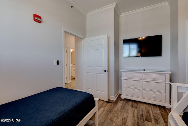 6627 Thomas Dr Unit 1702, Panama City Beach, FL 32408 - bedroom with crown molding, light wood-style floors, and baseboards