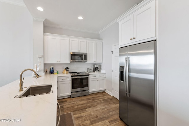 6627 Thomas Dr Unit 1702, Panama City Beach, FL 32408 - kitchen with ornamental molding, a sink, white cabinetry, stainless steel appliances, and decorative backsplash