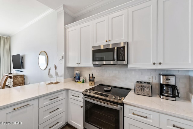 6627 Thomas Dr Unit 1702, Panama City Beach, FL 32408 - kitchen featuring ornamental molding, decorative backsplash, appliances with stainless steel finishes, a peninsula, and white cabinets