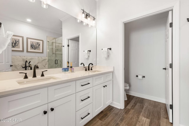 6627 Thomas Dr Unit 1702, Panama City Beach, FL 32408 - full bath featuring a shower stall, toilet, crown molding, and a sink