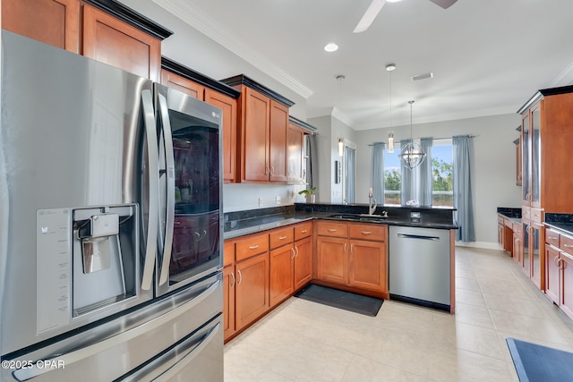 kitchen featuring brown cabinetry, appliances with stainless steel finishes, ornamental molding, a peninsula, and a sink