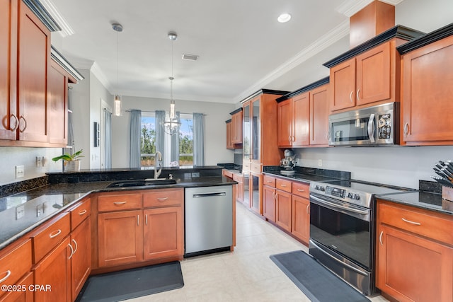 kitchen featuring brown cabinetry, ornamental molding, stainless steel appliances, and a sink