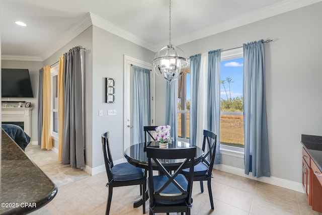 dining room with a fireplace, crown molding, a notable chandelier, light tile patterned floors, and baseboards