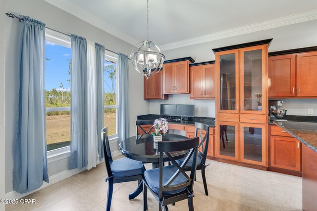 dining room featuring baseboards, crown molding, an inviting chandelier, and light tile patterned floors