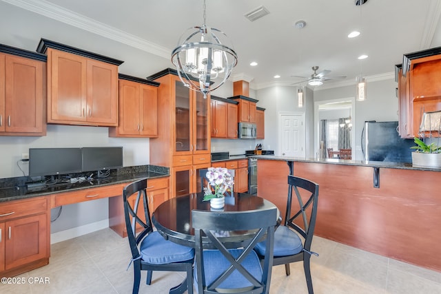 kitchen featuring ornamental molding, visible vents, stainless steel appliances, and built in study area