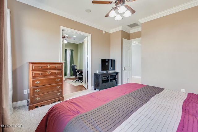 carpeted bedroom with ornamental molding, a ceiling fan, visible vents, and baseboards