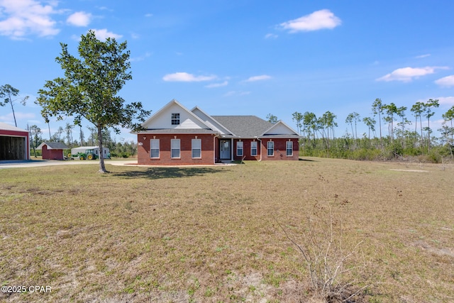 view of front of house featuring a front yard and brick siding